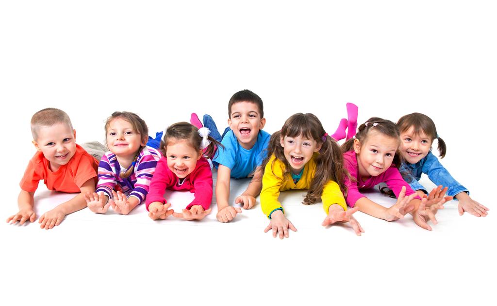 Group of seven playful children are lying on floor together